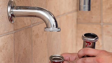 Drain Cleaning Service - Plumber fixing sink