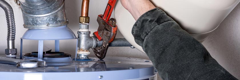 Water Heater Repair - Plumber Fixing Water Heater