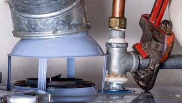 Water Heater Repair - Plumber Fixing Water Heater