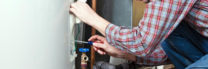 Water Heater Replacement - Plumber Fixing Heater